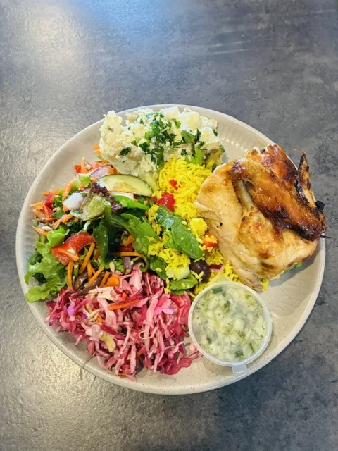 A full plate: roast chicken, rice, potato salad, coleslaw and garden salad