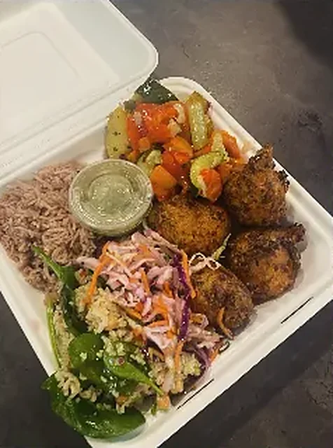 Takeaway box with acras, rice, salads and salsa