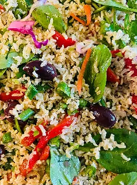 Rice salad with olives, spinach and capsicum